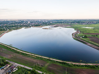 Beautiful Aerial view of a village and blue lake on summer day. 
