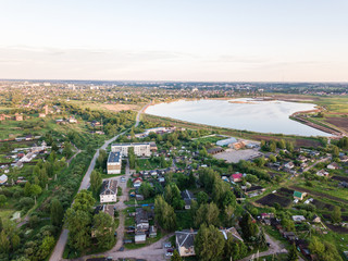 Beautiful Aerial view of a village and blue lake on summer day. 