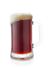 Mug of dark beer woth flow down foam on white