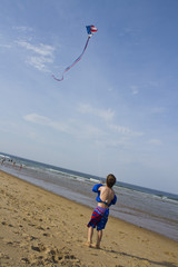 Child on a Beach Flying an American Flag Kite on the 4th of July