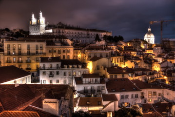 Fototapeta na wymiar View of old town of Lisbon at night from Miradouro de Santa Luzia 