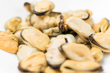 Peeled mussels on a white background.