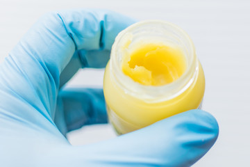 A jar with balm, cream.