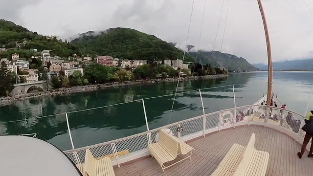 Tourist ship sails along the Lake Geneva to the Chillon Castle.