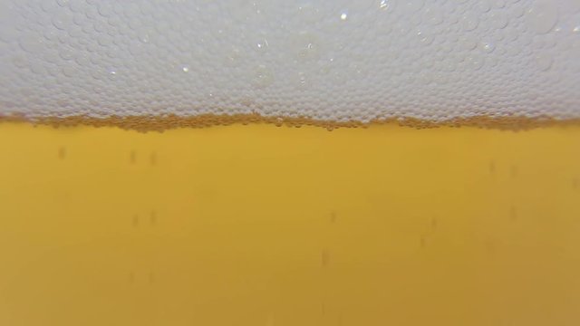 Beer poured into a glass of macro 05 / Macro shot you can see the foam bubbles