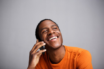 Close up happy black man talking on mobile phone and laughing