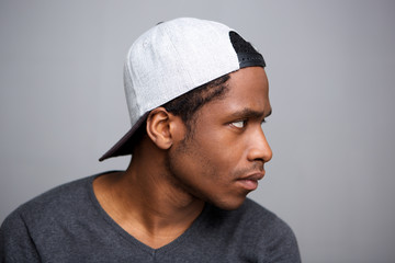 side portrait of cool african american man with cap on backwards