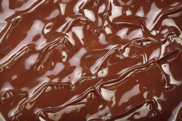 Melted chocolate swirl as a background closeup