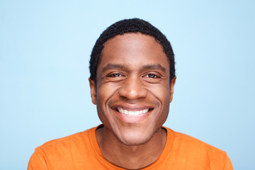 Close up african american man smiling against blue background