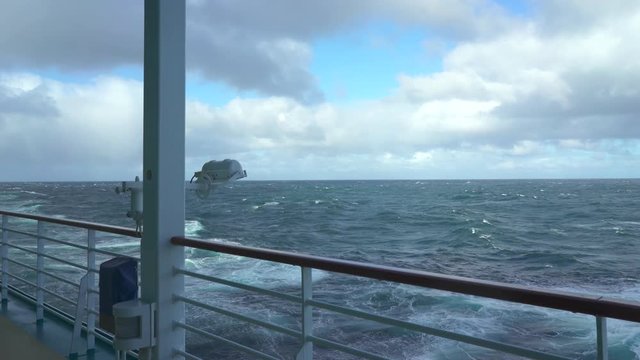 Cruise ship cruising at stormy ocean - starboard side view