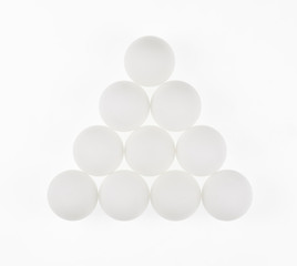 white abstract balls, eggs, geometric shapes, white background