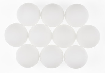 white abstract balls, eggs, geometric shapes, white background