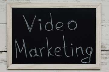 Video Marketing concept. Handwritten text at blackboard, top view