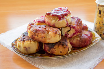 hot pie with berries, fried in oil, lined in a dish, a mug of cold milk, on a napkin