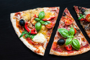 Slices of Traditional Italian Pepperoni  pizza on a black background with  Space for text. Pizza menu. Top view