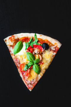 Slice of Pepperoni  pizza on a black background with  Space for text. Pizza menu. Top view