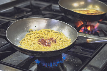 Cooking pan, spaghetti cooking in a professional italian kitchen