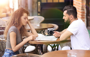 Beautiful loving couple sitting in a cafe enjoying in coffee