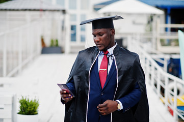African american happy successful student at graduation hat.