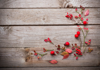 red autumn leaves on old wooden background