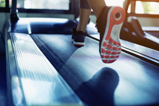 The feet of a woman running on a treadmill.motion Blur