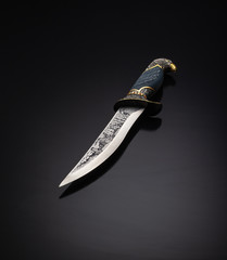 knife with an engraving on a black background
