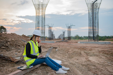 Engineer woman working at site of bridge under construction