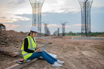 Engineer woman working at site of bridge under construction