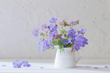 flowers in jug on white background