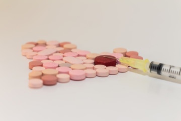 Numerous medicines Medications in the form of tablets. Colored pills on a white background.