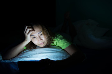 Asian woman play smartphone in the bed at night,Thailand people