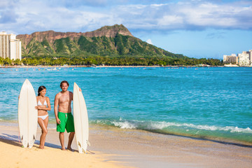 Hawaii surf couple on waikiki beach in Honolulu, Hawaii. Summer holidays travel destination young...
