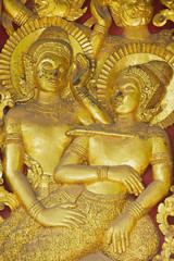 Detail of the ancient golden exterior wall decoration at Wat Xieng Thong Buddhist temple in Luang Prabang, Laos.