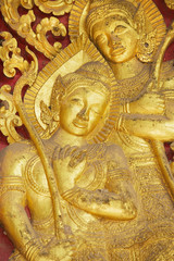 Fototapeta premium Detail of the ancient golden exterior wall decoration at Wat Xieng Thong Buddhist temple in Luang Prabang, Laos.
