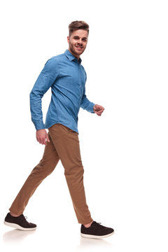 attractive young casual man walks to side