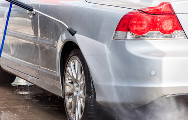 Non-contact car wash self-service. A man washes a car, Tarragona, Spain.