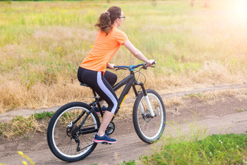 Naklejka premium Woman is riding a bicycle, an active lifestyle.