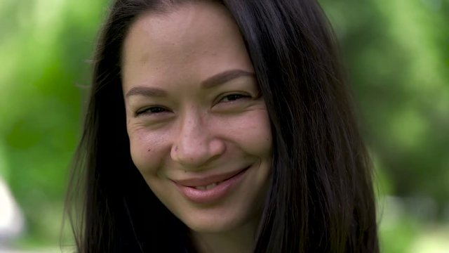 A portrait of a happy looking asian woman with a tears of happiness and cute smile. Close-up.