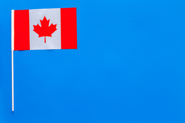 Fototapeta na wymiar Canadian flag concept. small flag on blue background top view copy space