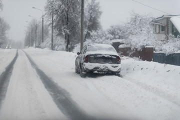 car in a street covered by a lot of snow