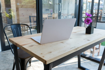 office desk workplace white laptop with tablet and flower on wood table in modern office