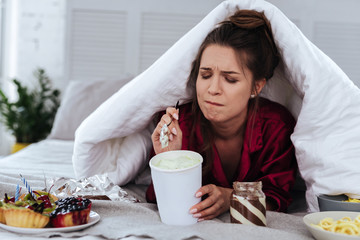 Lots of desserts. Heartbroken woman eating a lot of desserts because of depression and huge stress at work