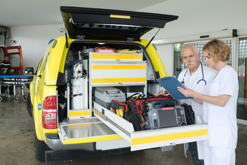 female and male doctor preparing an ambulance