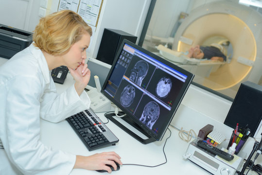 Medic studying brain scan images