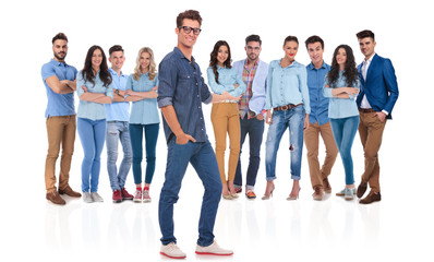 Obraz premium young casual man presenting his team standing behind