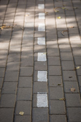 Street tiles on sun shadows