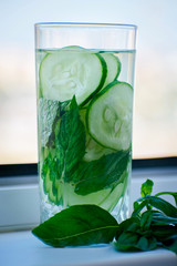 Fresh detox water with cucumber, mint and basil. Fresh cucumber water.