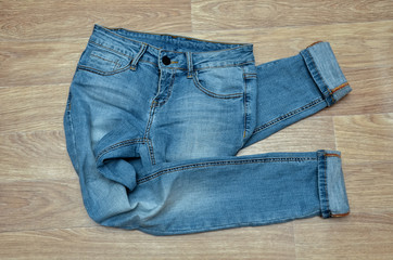 jeans on the background, blue jeans lie on a wooden background,