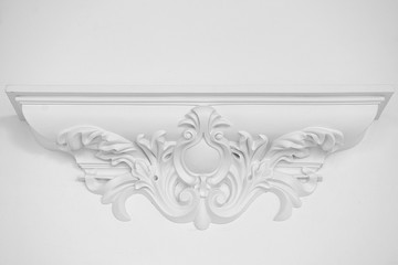 Stucco elements on white wall
