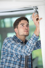 Young worker fitting cctv camera